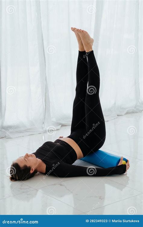 Woman Doing Stretching Warming Up Pilates Exercises Using Foam Roller