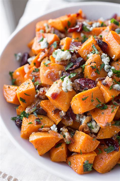 Roasted vegetable salad is tossed with potatoes in a light and flavorful dressing that's perfect for any meal or party. Warm Roasted Sweet Potato Salad with Apple-Smoked bacon