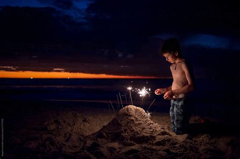 Babe At The Beach At Night With Sparklers By Stocksy Contributor Angela Lumsden Stocksy