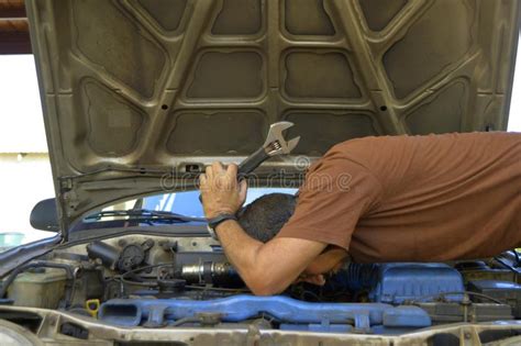 Middle Aged Man Trying To Repair Their Own Cars Stock Photo Image Of