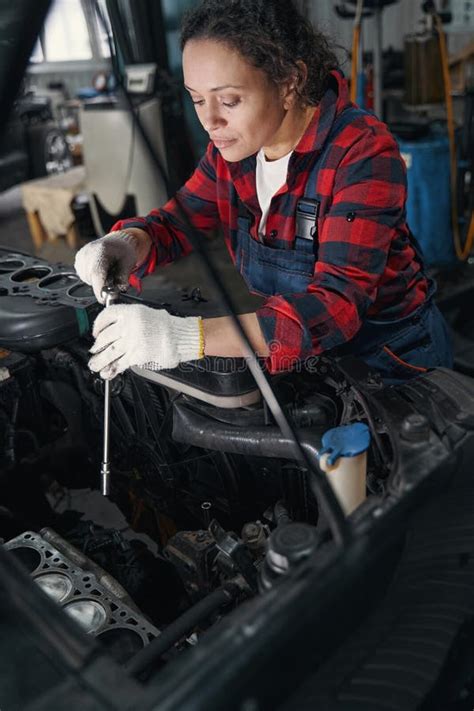 Female Auto Mechanic Repairing Car At Repair Service Station Stock