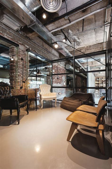 Industrial Office Features Exposed Bricks And Concrete Ceilings