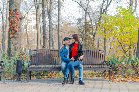 Happy Lovers In The Park On A Bench In Autumn Stock Photo Image Of