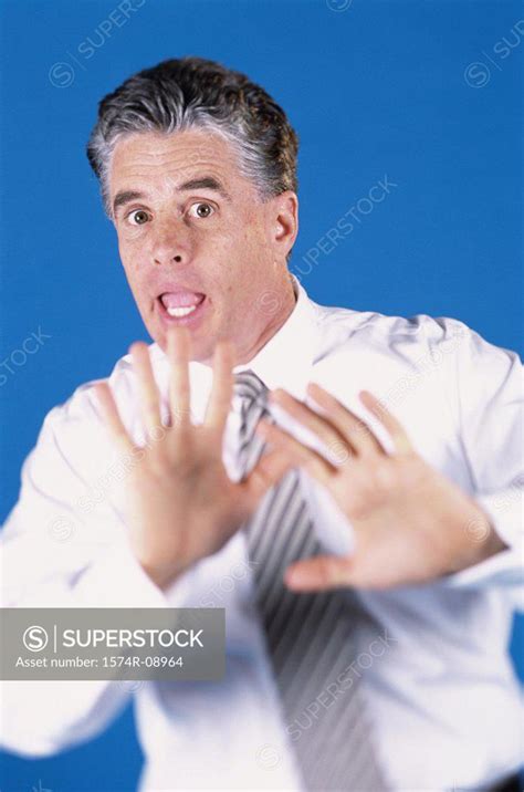 Portrait Of A Mid Adult Man With His Hands Raised Superstock