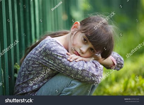 Sad Little Girl Sitting Alone On Stock Photo 257551324