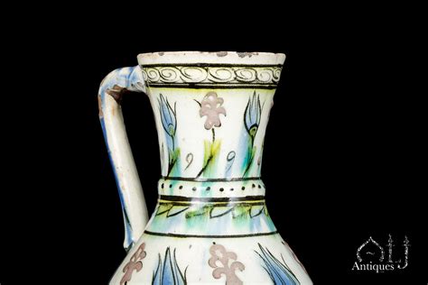 Iznik Ceramics An Iznik Underglaze Polychrome Painted Pottery Jug