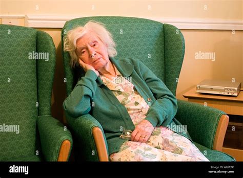 Unhappy Old Lady Aged 90 In Nursing Home Sitting In Armchair Stock