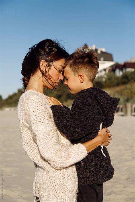 Young Mom Hugging Son At Beach By Danil Nevsky