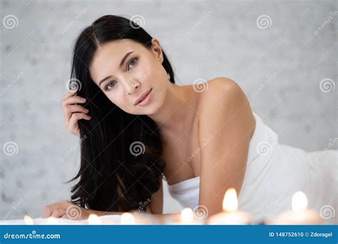Portrait Of Fresh And Beautiful Brunette Woman Lying Down On Massage Beds Relaxing In Spa Salon