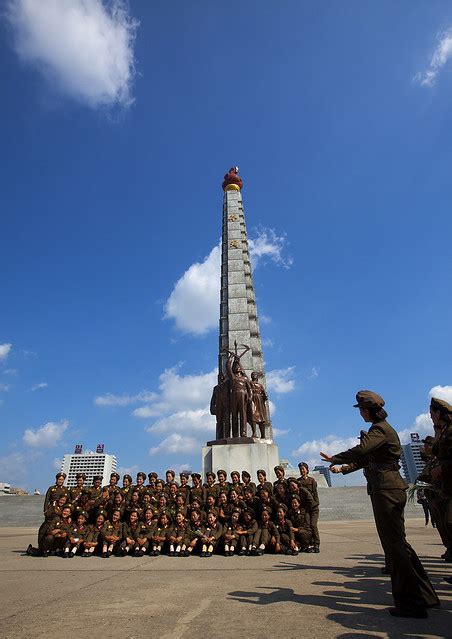 Female Soldiers Pausing In Front Of Tower Of The Juche Idea Pyongyang North Korea A Photo On