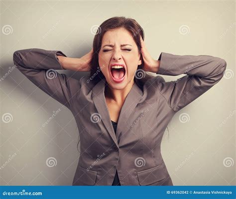 Angry Business Woman In Suit Strong Screaming With Wild Open Mouth And Holding Head The Hands