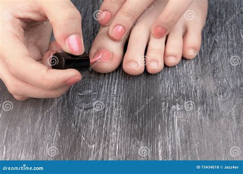 Teen Applaying Nail Polish To Hands And Feet Fingers Stock Photo