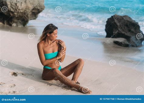 Tanned Girl In Blue Swimsuit Posing On Sunny Day At Sandy Beach Stock