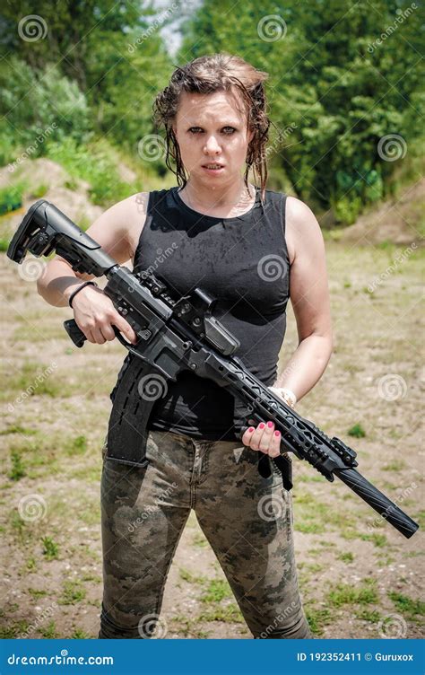 Wet Female Soldier Hold Rifle Machine Gun Woman With Weapon Stock