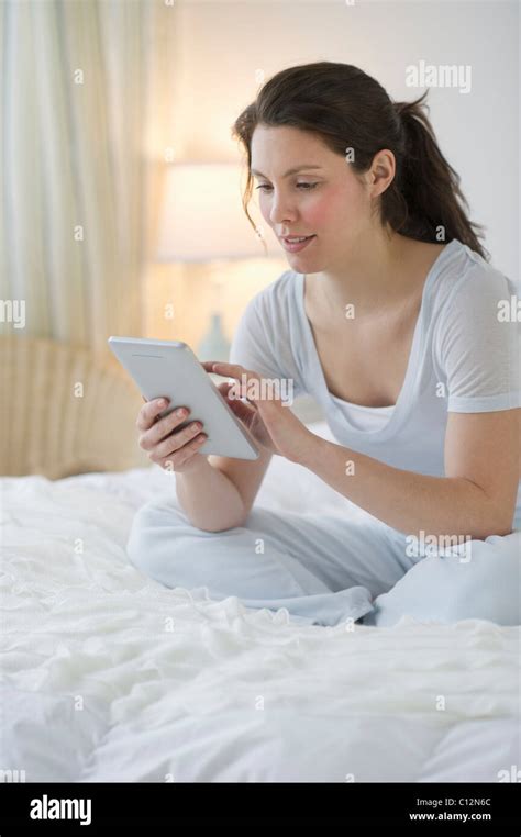 USA New Jersey Jersey City Woman Sitting In Bed Stock Photo Alamy