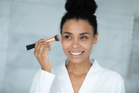 Head Shot Smiling African American Woman Applying Daily Makeup Stock