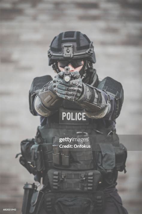 Swat Police Officer Against Brick Wall High Res Stock Photo Getty Images
