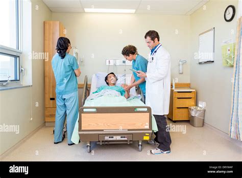 Nurses And Doctor Examining Patient In Hospital Stock Photo Alamy