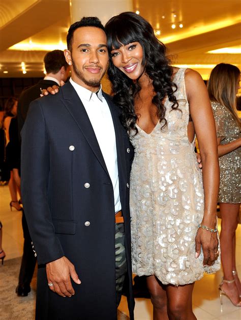 A Captured Moment Of Lewis Hamilton And Naomi Campbell Celebrating At
