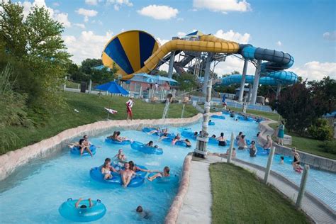 People Are In The Water At An Amusement Park With Blue And Yellow