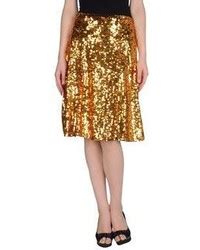 Longueur midi, coupe évasée et plissé soleil : Comment porter une jupe plissée dorée pour un style ...
