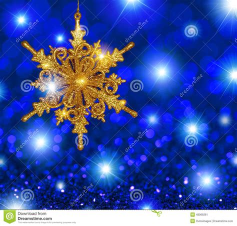 Gold Snowflake Star On Blue Stars Background Stock Photo