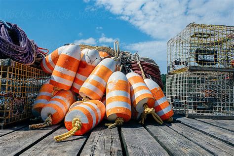Pile Of Orange And White Lobster Trap Buoys And Traps On A Dock Del