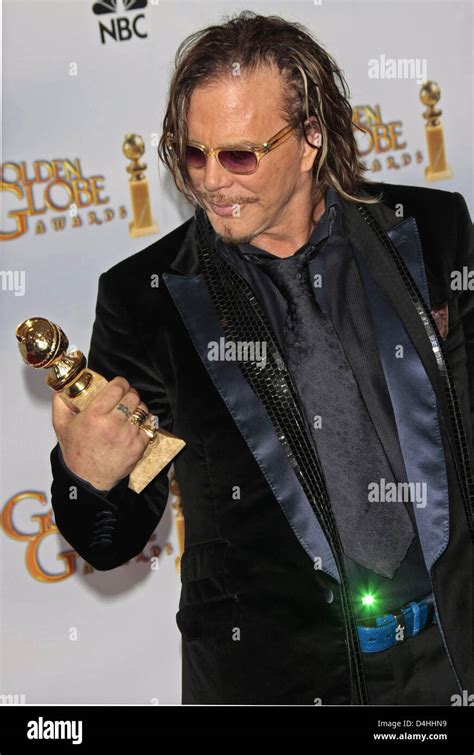 Actor Mickey Rourke Poses With His Award For Best Performance By An
