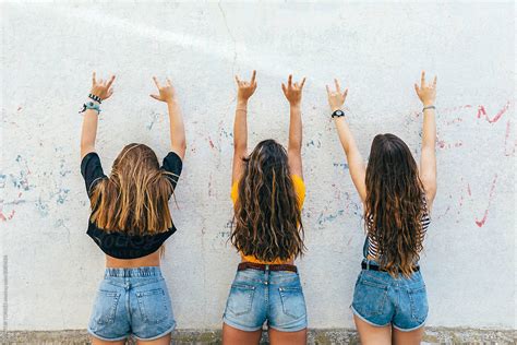 Three Naughty Teen Girls Making The Rock Sign Giving Back To Camera