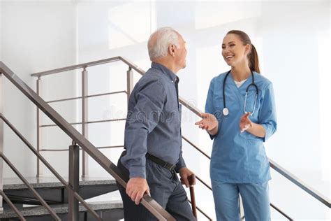 Doctor Helping Senior Patient In Hospital Stock Image Image Of