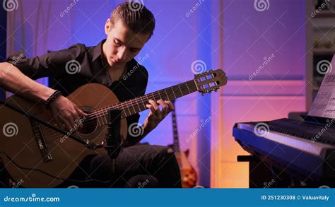 Man Plays Guitar Young Man Plays A Musical Instrument Stock Photo