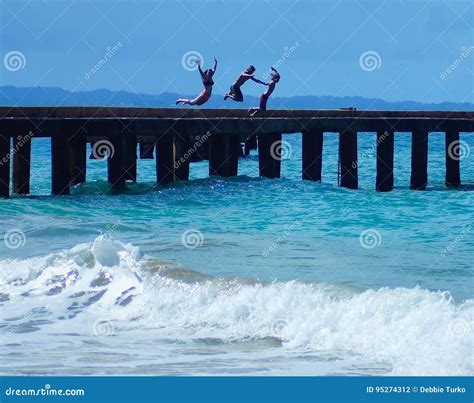 Kids Jumping Off Pier Into Ocean In Puerto Rico Stock Photo Image Of