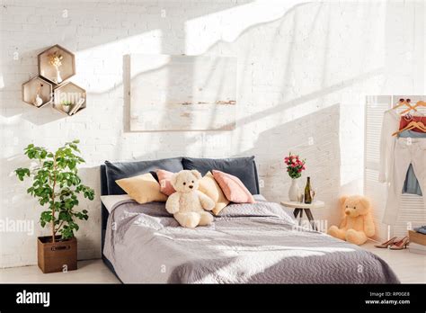 Modern Interior Design Of Bedroom With Teddy Bear Toys Pillows Plants