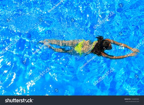 Woman With Swimsuit Swimming On A Blue Water Pool Stock Photo 143405392