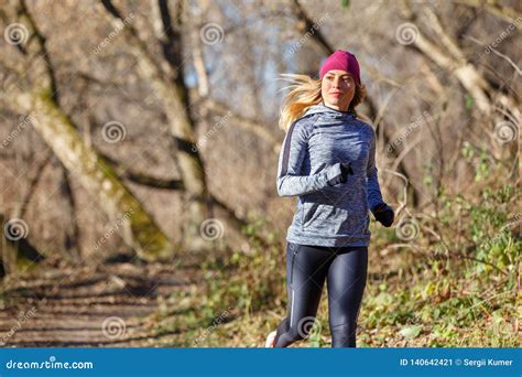 Young Woman Jogging On Trail In Autumn Park Stock Image Image Of