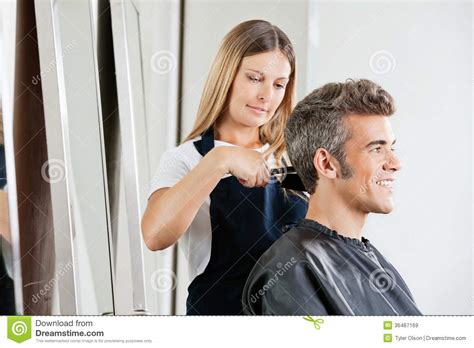 Female Hairdresser Cutting Clients Hair Royalty Free