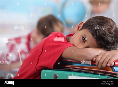 Sleepy Boy In Classroom Stock Photo Alamy