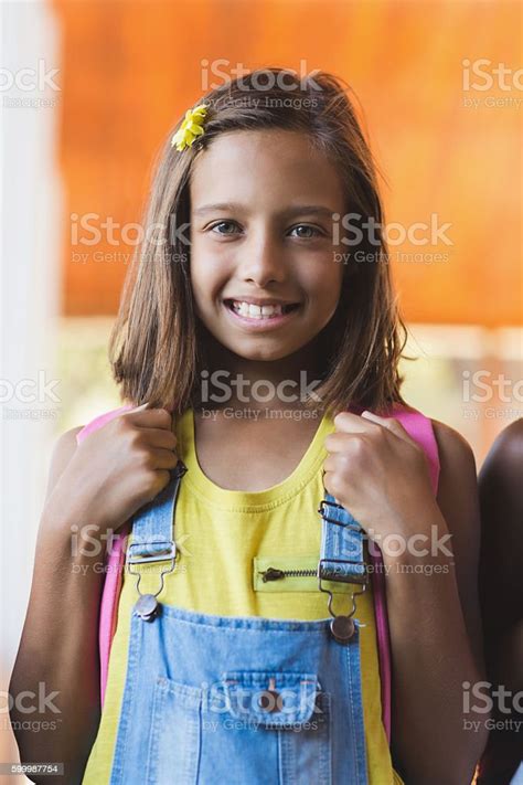 Portrait Of School Girl Standing In School Corridor Stock Photo