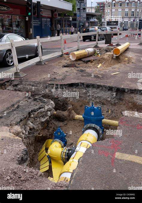 New Pipes Being Installed In Hole Under Road Stock Photo Alamy
