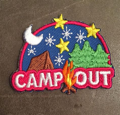 A Patch With The Words Camp Out In Front Of A Mountain And Firepith