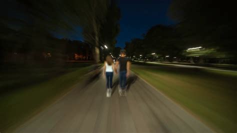 The Man And Woman Walking In The Park Evening Night Time Hyperlapse