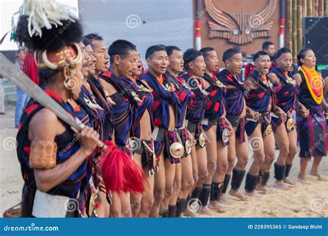 Naga Tribesmen And Women Dressed In Their Traditional Attire Dancing