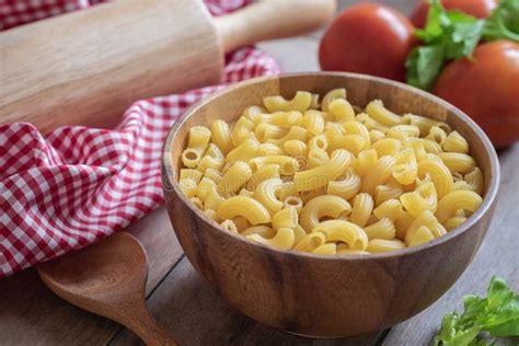 Raw Macaroni Pasta In Wooden Bowl And Egg In Basket Stock Photo Image