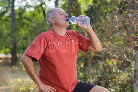Middle Aged Man Drinking Water From Bottle Stock Photo Stock Image