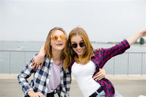 Two Smiling Female Friends Hugging Each Other Street Holidays Vacation