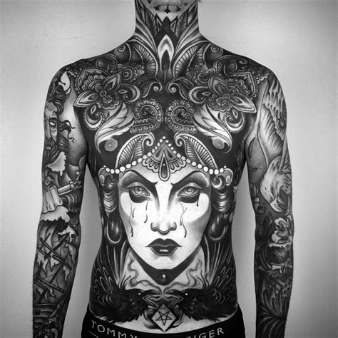 A Man With Tattoos On His Body And Chest