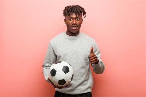 Premium Photo Young Fitness Black Man Holding A Soccer Ball Cheerful