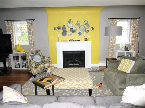 A Living Room With Yellow Walls And Gray Furniture