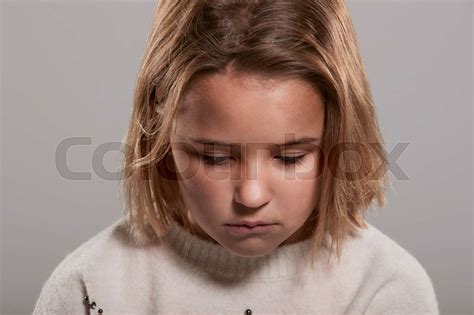 Sad Nine Year Old Girl Looking Down Head And Shoulders Stock Image