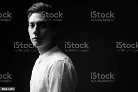 Studio Shot Of Young Multiethnic Handsome Man Against Black Background